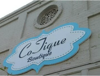 CoJique Boutique sign on the front of building