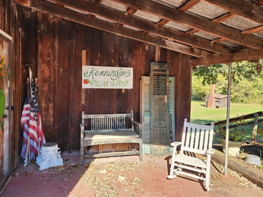 front porch with rock chair and american flag - Kennington's in Historic Juliette, GA home to Fried Green Tomatoes