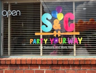 S&C Party Your Way window sign